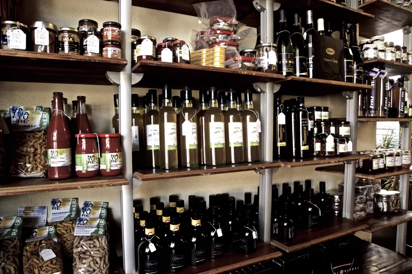 Gli scaffali di Gustò con olio, conserve e vini